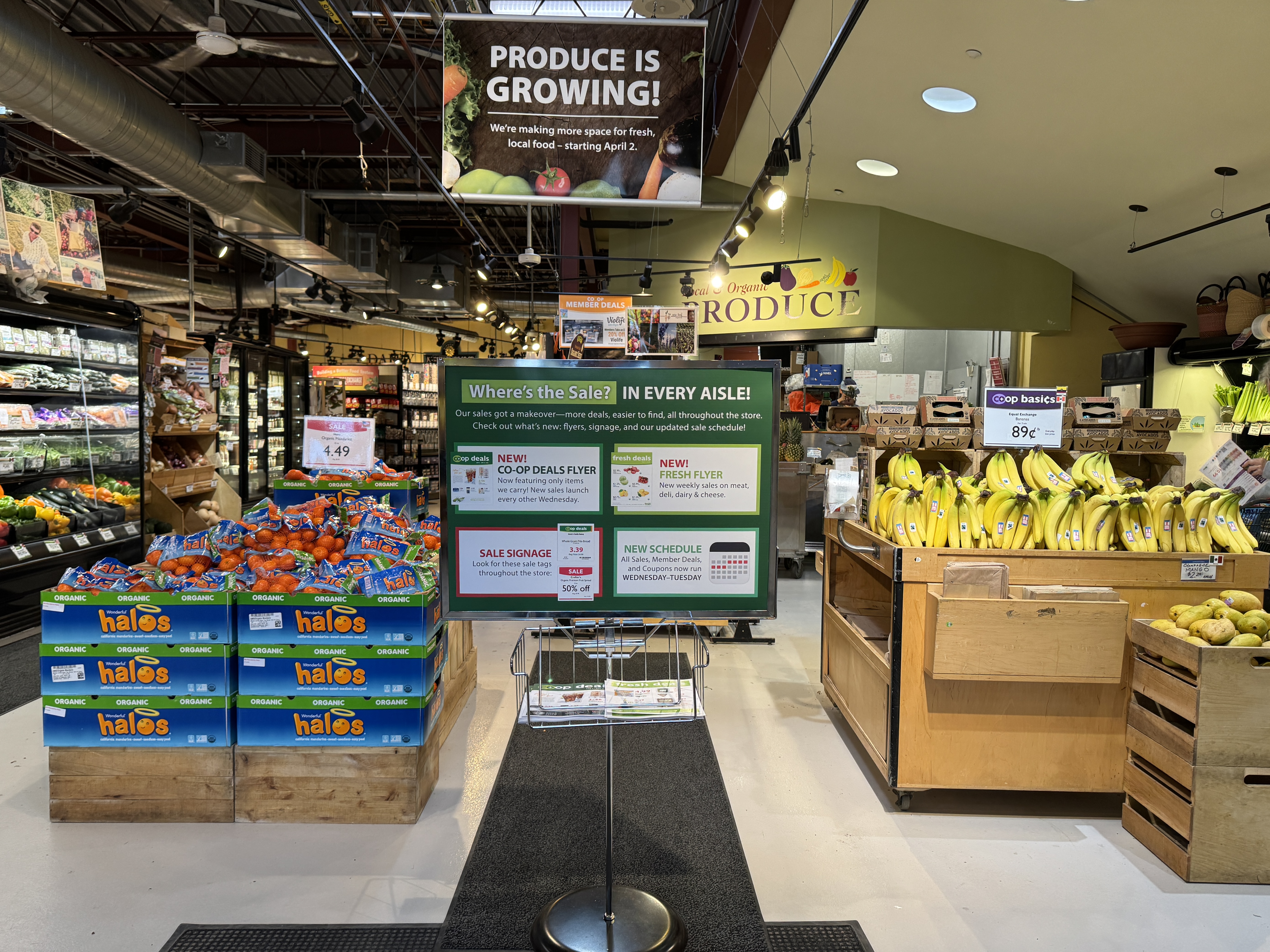 Photo of produce section with sign announcing changes