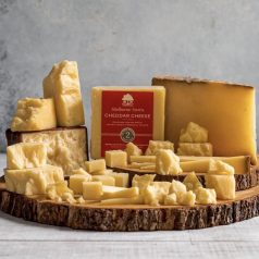 cheddar cheese on a wooden board