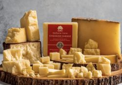 cheddar cheese on a wooden board