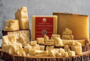 cheddar cheese on a wooden board