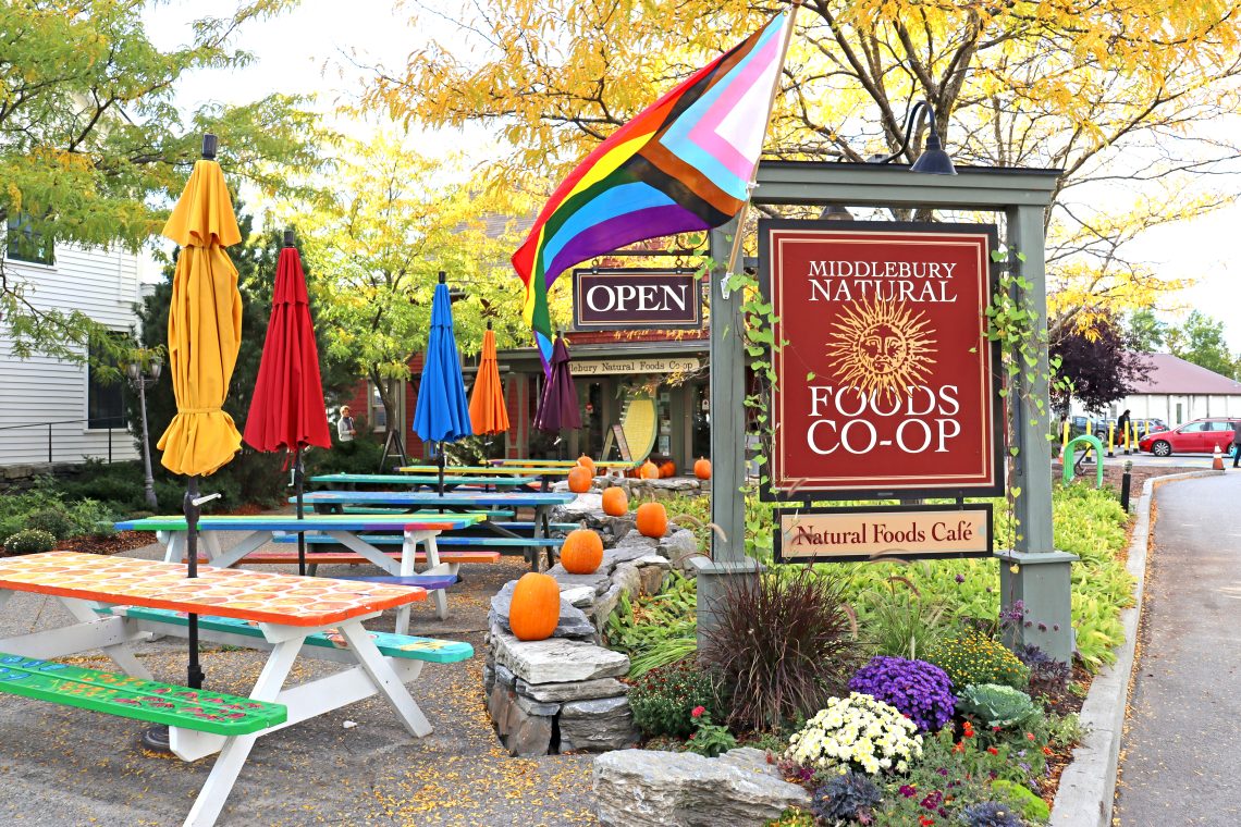 Co-op exterior in fall with pride flag